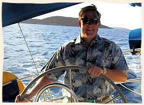 island groom at the helm