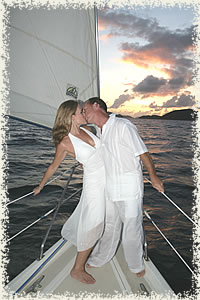 kiss on the bow sunset wedding