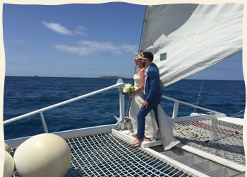 Wedding couple bow of sailboat Virgin Islands